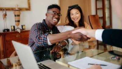 An agent shaking hands with a couple